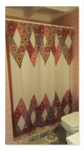 a bathroom with a toilet and a shower curtain at Porto Gavrio Loft in Gavrio