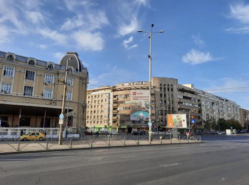 an empty street in a city with tall buildings at Luxury City Center Apartment - Bucharest Railways Station in Bucharest