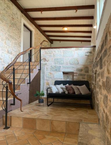 a man sleeping on a bed in a room with a stone wall at Casa Istriana Vrsar in Vrsar