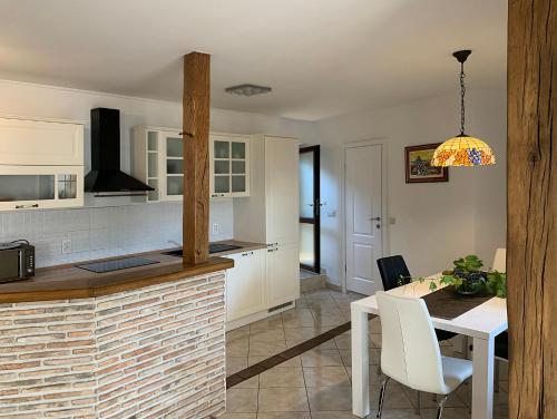 a kitchen and dining room with a table and chairs at Casa Istriana Vrsar in Vrsar