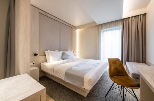 a hotel room with a bed and a desk at Begijnhof Hotel in Leuven