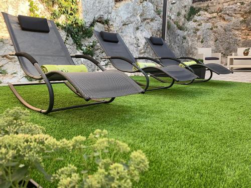 a row of chairs sitting on the grass at Casa Istriana Vrsar in Vrsar