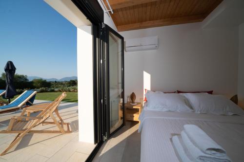 A bed or beds in a room at Ionian Trilogy Luxury Villas