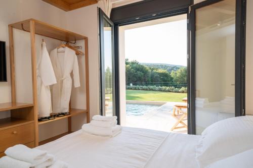 A bed or beds in a room at Ionian Trilogy Luxury Villas
