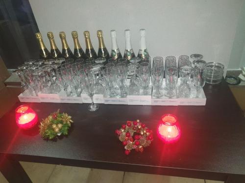 a group of wine glasses on a table with candles at Safi in Dospat