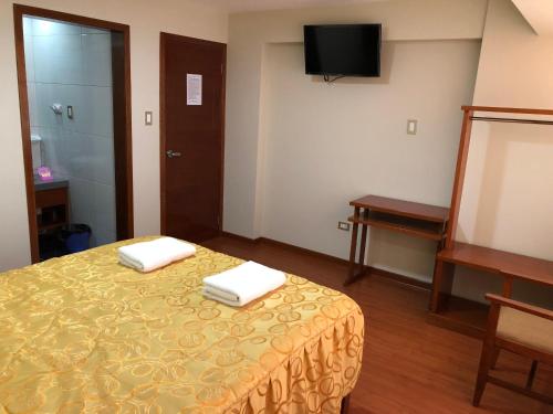 Postel nebo postele na pokoji v ubytování Sumaq Hotel Tacna
