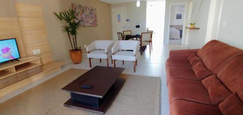 a living room with a couch and a table at Atlantic Palace Family inn in Aquiraz