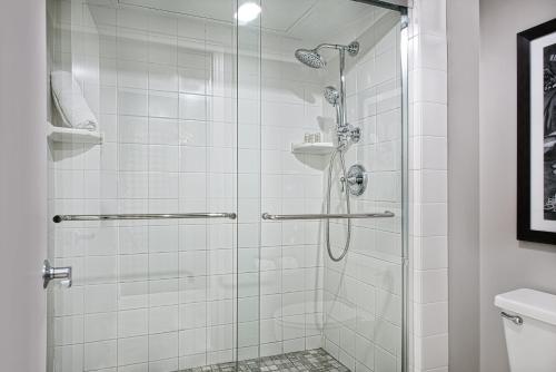 a bathroom with a shower with a glass door at Hotel Indigo Dallas Downtown, an IHG Hotel in Dallas