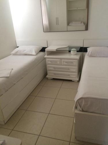 熱河市的住宿－Águas da Serra Apart Service 728A，一间小卧室,配有两张床和镜子