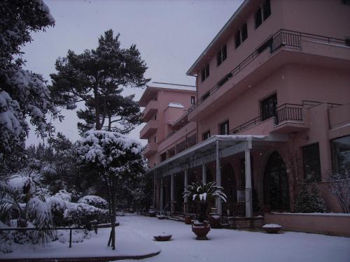 a building with snow on the ground in front of it at Park Hotel San Michele in Martina Franca