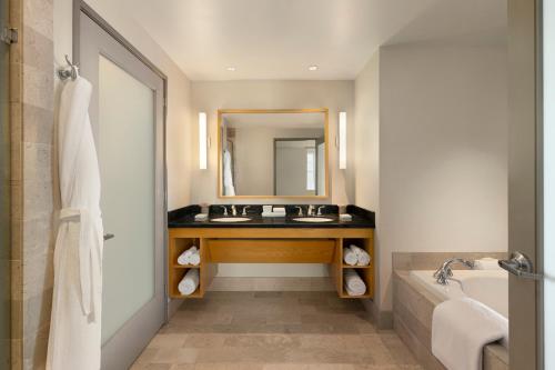 a bathroom with a sink, toilet and bathtub at InterContinental The Clement Monterey, an IHG Hotel in Monterey