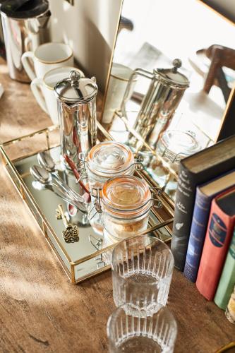 a serving tray with glasses on a table with books at The Swan Inn in Winscombe