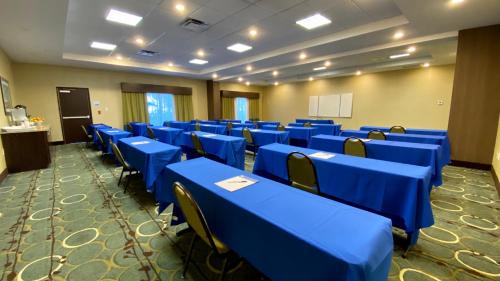 a conference room with blue tables and chairs at Holiday Inn Express Hotel & Suites Orlando East-UCF Area by IHG in Orlando