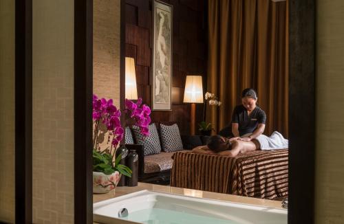a woman laying on a couch in a hotel room at InterContinental Shijiazhuang by IHG in Shijiazhuang