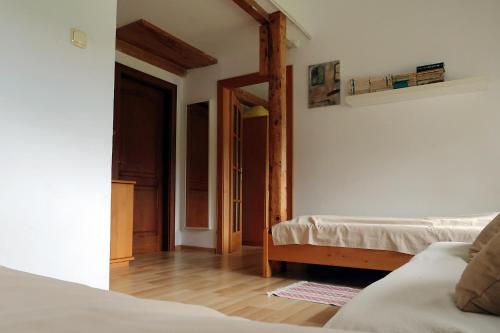 a bedroom with two beds and an open door at Gospodarstwo Agroturystyczne LOBELIA in Pomysk Wielki