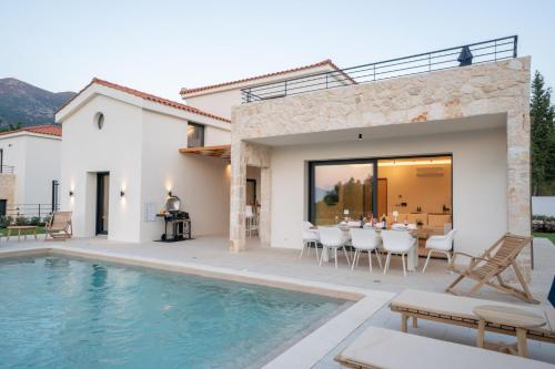 a villa with a swimming pool and a patio at Ionian Trilogy Luxury Villas in Sami