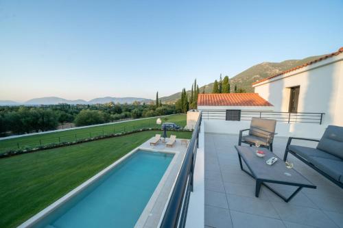 a patio with a swimming pool next to a house at Ionian Trilogy Luxury Villas in Sami