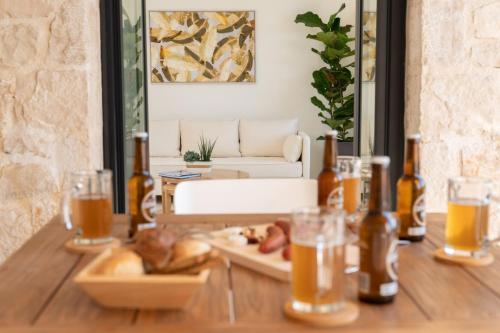 a table with a tray of food and bottles of beer at Ionian Trilogy Luxury Villas in Sami