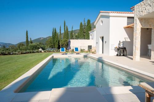 a swimming pool in the backyard of a house at Ionian Trilogy Luxury Villas in Sami