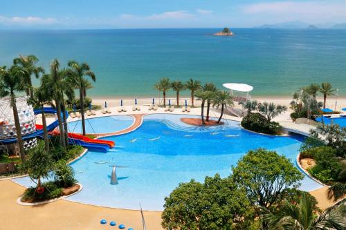 an aerial view of a resort swimming pool with the beach at Intercontinental Shenzhen Dameisha Resort by IHG in Shenzhen