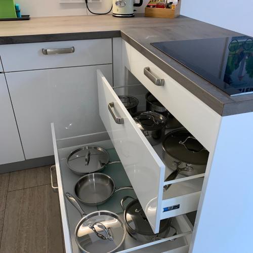 an open kitchen drawer with pots and pans at Park-Lodge Am Rohrbusch in Münster
