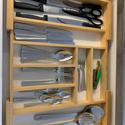 a wooden drawer filled with lots of utensils at Park-Lodge Am Rohrbusch in Münster