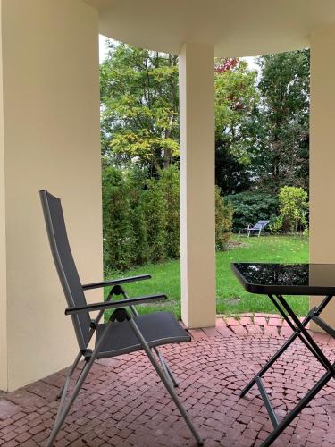 a chair and a table on a brick patio at Park-Lodge Am Rohrbusch in Münster