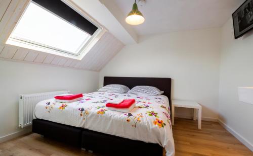 a bedroom with a bed with red shoes on it at Bij Jans in Hilvarenbeek
