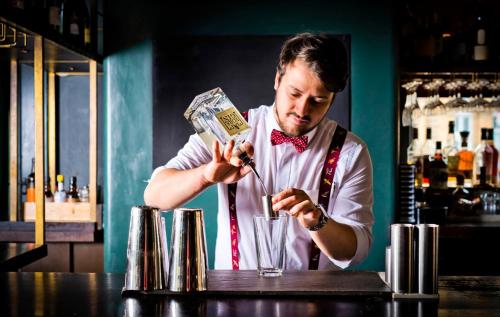 a man standing at a bar with a bunch of money at The Milner York in York