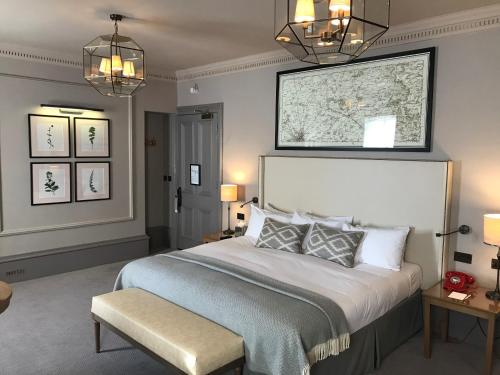 a bedroom with a large bed and two lights at The Milner York in York