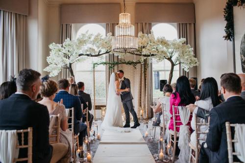 a bride and groom walking down the aisle at their wedding ceremony at The Milner York in York