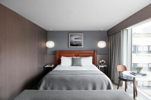 a hotel room with a bed and a window at Kimpton Blythswood Square Hotel & Spa by IHG in Glasgow