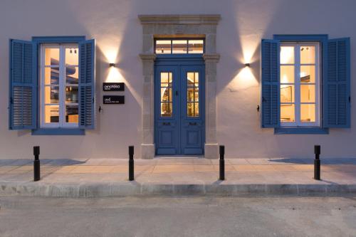 a building with blue windows and a blue door at Hotel Indigo Larnaca by IHG-ADULTS ONLY in Larnaka