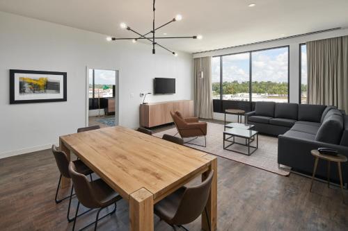 a living room with a table and a couch at Hotel Indigo Tallahassee - Collegetown by IHG in Tallahassee