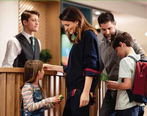 a woman talking to a group of people at Hotel Indigo Madrid - Princesa by IHG in Madrid