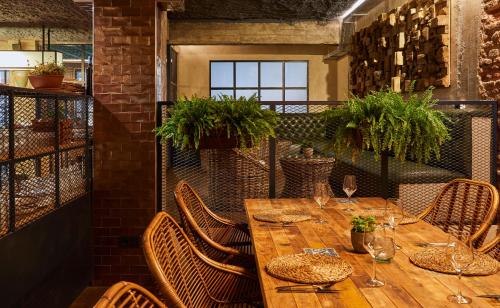 a wooden table and chairs in a room at Hotel Indigo Madrid - Princesa by IHG in Madrid