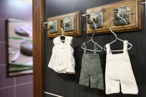 a pair of panties and apron hanging on a wall at Hotel Złoty Młyn Majków in Piotrków Trybunalski