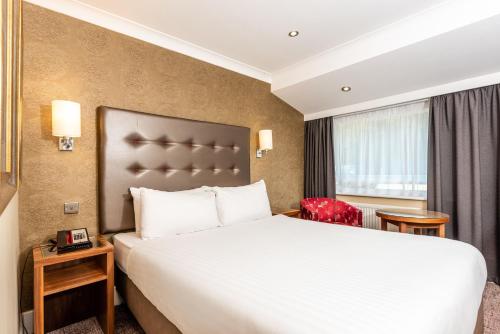 a hotel room with a bed and a window at Holiday Inn Dover by IHG in Dover
