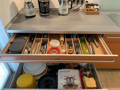 a kitchen drawer filled with lots of kitchen items at Park-Lodge Am Rohrbusch in Münster