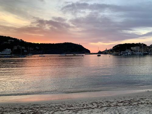 a body of water with a beach and a city at Hotel Miramar in Port de Soller