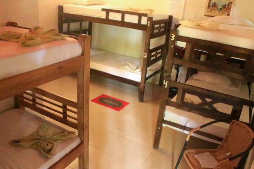 a group of bunk beds in a room at La Natura Hostel & Pool in Palomino