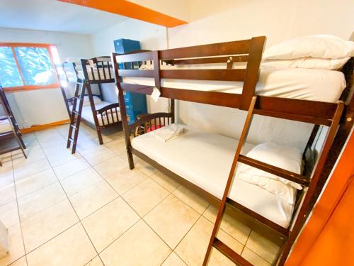 a room with two bunk beds in a room at ITH Beach Bungalow Surf Hostel San Diego in San Diego