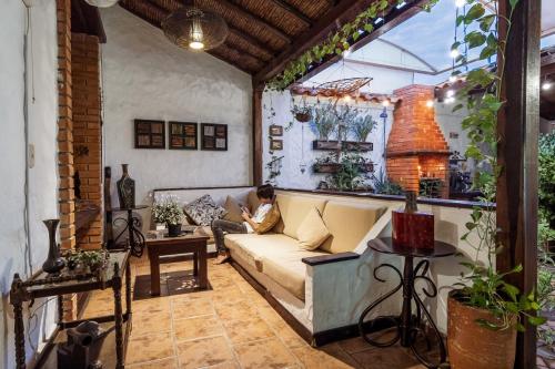 a man sitting on a couch in a living room at Giron Chill Out Hotel Boutique in Girón