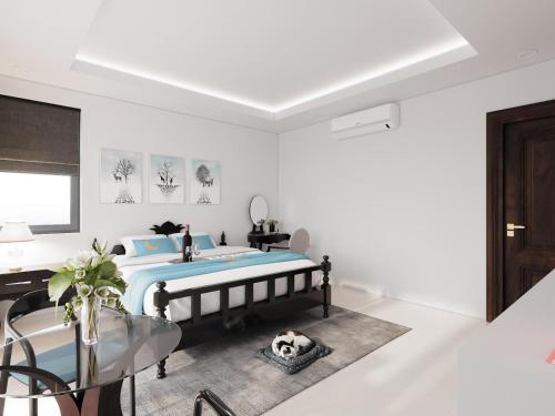 a bedroom with a bed and a glass table at Luna Oriental in Phu Quoc