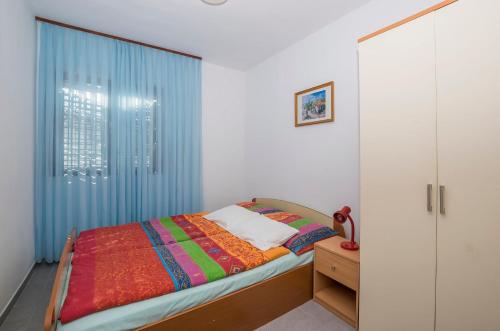 a bedroom with a bed and a window at Apartments Green Street in Batalaži