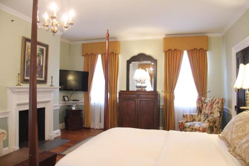a bedroom with a large bed and a large window at Morris House Hotel in Philadelphia