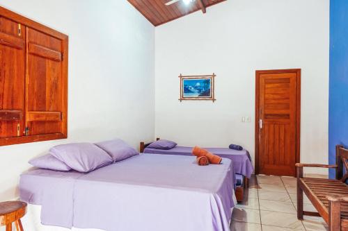 Katil atau katil-katil dalam bilik di Surf Red House - 3 quartos c ar - 50m da Rua Principal