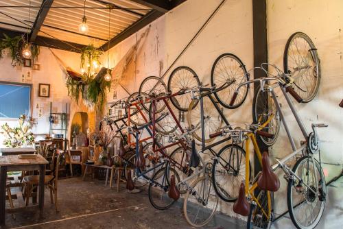 a bunch of bikes hanging on a wall at Exclusive Accommodation 9bicycle 9ppl in Tokyo