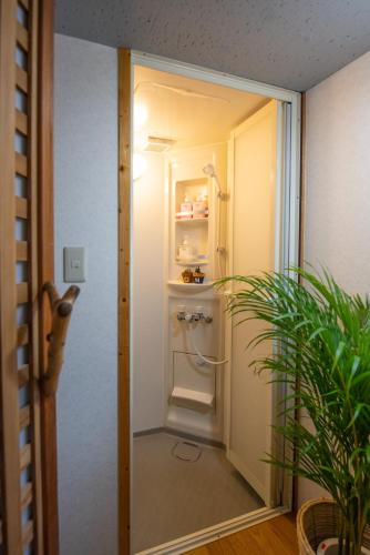 a bathroom with a small refrigerator in a room at Exclusive Accommodation 9bicycle 9ppl in Tokyo