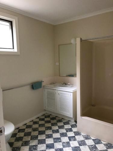 a bathroom with a sink and a mirror at RiverCottage-selfcontained in Marysville